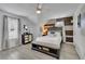 Spacious bedroom with wood accent wall, ceiling fan, and a seating bench at 1701 English Ivey Nw Ln, Kennesaw, GA 30144