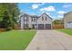 Charming two-story home featuring a manicured front yard and a two-car garage at 1701 English Ivey Nw Ln, Kennesaw, GA 30144