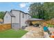 View of the home's exterior showing the patio, landscaping, and hardscaping at 1701 English Ivey Nw Ln, Kennesaw, GA 30144
