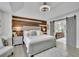 Primary bedroom suite with wood accent wall, barn doors, and en-suite bathroom at 1701 English Ivey Nw Ln, Kennesaw, GA 30144