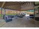 Spacious covered patio with stone floor, outdoor seating, dining area, grill, and fenced yard at 1701 English Ivey Nw Ln, Kennesaw, GA 30144