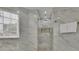 Bright glass-enclosed shower features mosaic tile flooring and a marble tile surround and is well lit at 1701 English Ivey Nw Ln, Kennesaw, GA 30144