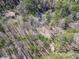 Aerial view of a home nestled in a dense forest offering privacy and seclusion at 5090 Eubanks Rd, Woodstock, GA 30188