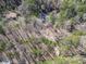 Aerial view of a home nestled in a dense forest offering privacy and seclusion at 5090 Eubanks Rd, Woodstock, GA 30188