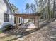 Pergola with dining table and chairs on a red brick patio at 5090 Eubanks Rd, Woodstock, GA 30188