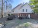 Back exterior featuring a brick foundation, a wooden deck and an easy-access doorway at 5090 Eubanks Rd, Woodstock, GA 30188