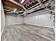 Basement featuring open unfinished ceiling, hardwood flooring, and grey painted walls at 5090 Eubanks Rd, Woodstock, GA 30188