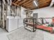 Unfinished basement with a washer, dryer, exposed ducts and wood beams at 5090 Eubanks Rd, Woodstock, GA 30188