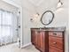 Bathroom featuring a wooden vanity with granite counters, modern fixtures, and tile flooring at 5090 Eubanks Rd, Woodstock, GA 30188