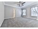 Bedroom features a ceiling fan, neutral paint, carpet, and an ensuite bath at 5090 Eubanks Rd, Woodstock, GA 30188