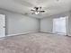 Bright, carpeted bedroom featuring a ceiling fan and walk-in closet at 5090 Eubanks Rd, Woodstock, GA 30188