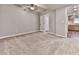 Bedroom features carpeting, neutral walls, and an open doorway leading to the kitchen at 5090 Eubanks Rd, Woodstock, GA 30188