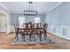 Elegant dining room with wainscoting, stylish rug, and modern light fixture at 5090 Eubanks Rd, Woodstock, GA 30188