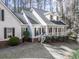 Attractive two-story home with white siding, dormer windows and a covered front porch at 5090 Eubanks Rd, Woodstock, GA 30188