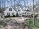 Charming two-story home featuring a welcoming front porch, black shutters, and well-maintained landscaping in a wooded setting at 5090 Eubanks Rd, Woodstock, GA 30188