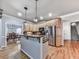 Bright kitchen with wood cabinets, granite counters, stainless steel appliances, and hardwood flooring at 5090 Eubanks Rd, Woodstock, GA 30188