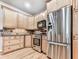 Well-lit kitchen showcasing stainless steel appliances and wood cabinets at 5090 Eubanks Rd, Woodstock, GA 30188