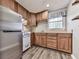 Kitchenette featuring wood cabinets, stainless steel refrigerator, and laminate countertop at 5090 Eubanks Rd, Woodstock, GA 30188