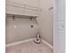 Utility room with shelves, hook rail, and tiled flooring at 5090 Eubanks Rd, Woodstock, GA 30188