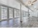 Bright living room features hardwood floors, ceiling fans, large windows, and natural light at 5090 Eubanks Rd, Woodstock, GA 30188