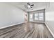 Living room has wood flooring, a ceiling fan, neutral walls, and access to the kitchen and backyard at 5090 Eubanks Rd, Woodstock, GA 30188