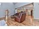 Open-concept living room with a vaulted ceiling, fireplace, hardwood floors, and an easy transition to the adjacent kitchen at 5090 Eubanks Rd, Woodstock, GA 30188
