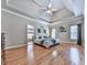 Spacious main bedroom with a tray ceiling, ceiling fan, and ensuite bath access at 5090 Eubanks Rd, Woodstock, GA 30188