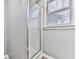 Shower stall with glass doors and a window providing natural light at 5090 Eubanks Rd, Woodstock, GA 30188