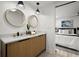 Contemporary bathroom featuring dual sinks, stylish lighting, and a bedroom view at 569 Oakside Sw Dr, Atlanta, GA 30331