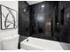 Bathroom featuring black marble tile surround with a bathtub at 569 Oakside Sw Dr, Atlanta, GA 30331