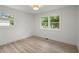 Bright bedroom with modern wood flooring and large windows providing natural light and backyard views at 569 Oakside Sw Dr, Atlanta, GA 30331