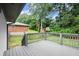 Backyard featuring a wooden deck with railing and a lush green lawn at 569 Oakside Sw Dr, Atlanta, GA 30331