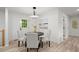 Bright dining room with a round table, modern lighting, and neutral decor at 569 Oakside Sw Dr, Atlanta, GA 30331