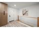 Modern entryway featuring wood cabinets, a staircase with cable railing, and wood-look flooring at 569 Oakside Sw Dr, Atlanta, GA 30331