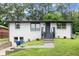 Inviting one-story house boasts a freshly painted exterior and manicured lawn at 569 Oakside Sw Dr, Atlanta, GA 30331
