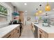 Contemporary kitchen featuring light wood cabinets, stainless steel appliances, and a unique backsplash at 569 Oakside Sw Dr, Atlanta, GA 30331