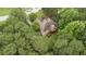 Drone shot shows house with large trees, backyard deck, and landscaped lawn highlighting privacy at 775 Tribble Cove Dr, Lawrenceville, GA 30045