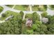 An aerial view of home highlighting surrounding trees, the roof, and location on a quiet street at 775 Tribble Cove Dr, Lawrenceville, GA 30045