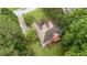 An aerial view of home showcasing the roof, green backyard and beautiful trees surrounding the property at 775 Tribble Cove Dr, Lawrenceville, GA 30045