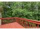 Relax on this spacious back deck overlooking a private backyard surrounded by lush greenery and mature trees at 775 Tribble Cove Dr, Lawrenceville, GA 30045