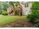 Exterior showcasing a multi-level deck with access to a spacious backyard and partial basement at 775 Tribble Cove Dr, Lawrenceville, GA 30045