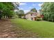 Lush green backyard featuring walkout basement, two-story deck, and large grassy area perfect for outdoor activities at 775 Tribble Cove Dr, Lawrenceville, GA 30045