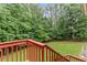 Inviting back yard view from deck showcasing the professionally landscaped lawn and lush green foliage at 775 Tribble Cove Dr, Lawrenceville, GA 30045
