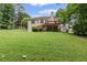 Expansive green backyard featuring a wooden deck and walkout basement, perfect for outdoor living at 775 Tribble Cove Dr, Lawrenceville, GA 30045