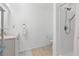 Bright bathroom with white vanity, shower, and a decorative mirror at 775 Tribble Cove Dr, Lawrenceville, GA 30045