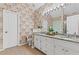 This bathroom features a double vanity with granite counters, tile floor, and floral wallpaper at 775 Tribble Cove Dr, Lawrenceville, GA 30045