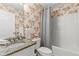 This bathroom features a combination tub and shower with granite counter at 775 Tribble Cove Dr, Lawrenceville, GA 30045