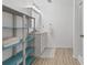 Clean bathroom with a blue accent shelving, a white vanity, and a shower at 775 Tribble Cove Dr, Lawrenceville, GA 30045