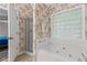 This bathroom features a combination tub and shower with a glass block window at 775 Tribble Cove Dr, Lawrenceville, GA 30045