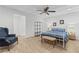 Bright bedroom with a blue chair, two windows, a decorative ceiling, and hardwood flooring at 775 Tribble Cove Dr, Lawrenceville, GA 30045
